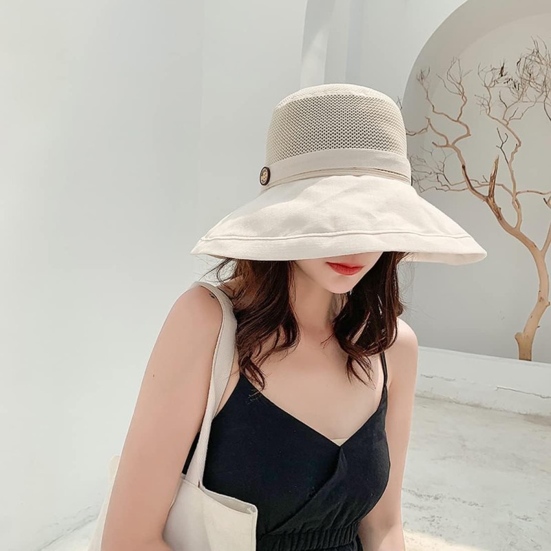 Women wearing a wide brim sun hat with mesh crown, wired edge, and chin strap for UV protection outdoors