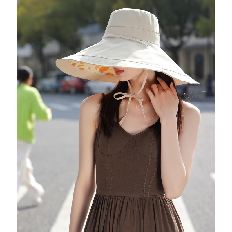 Woman wearing wide brim sun hat with UPF 50+ protection at beach