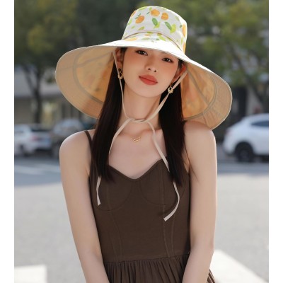 Woman wearing wide brim sun hat with UPF 50+ protection at beach