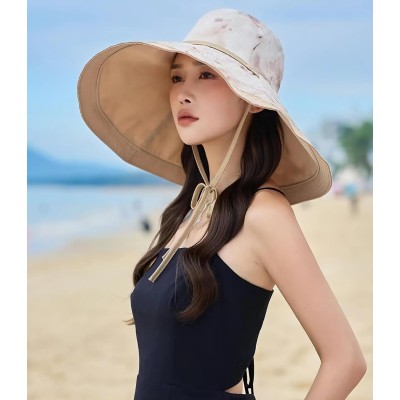 Woman wearing reversible wide brim sun hat with metal wired edge at beach