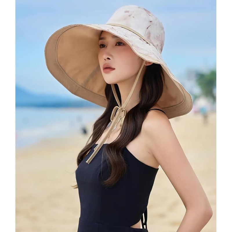 Woman wearing reversible wide brim sun hat with metal wired edge at beach