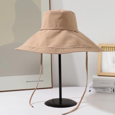 Woman wearing reversible wide brim sun hat with metal wired edge at beach