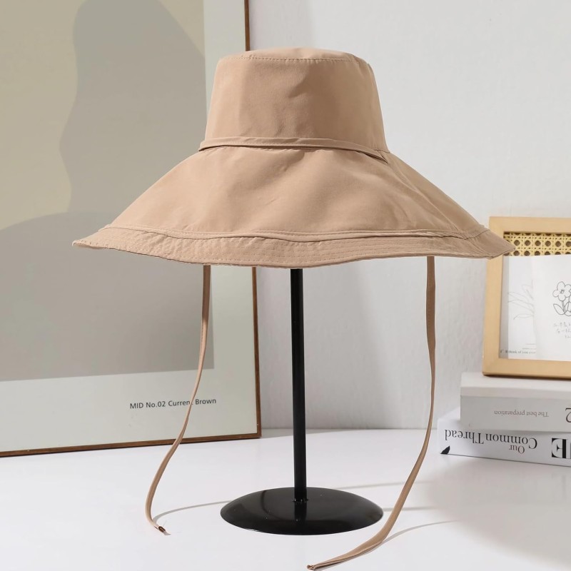 Woman wearing reversible wide brim sun hat with metal wired edge at beach
