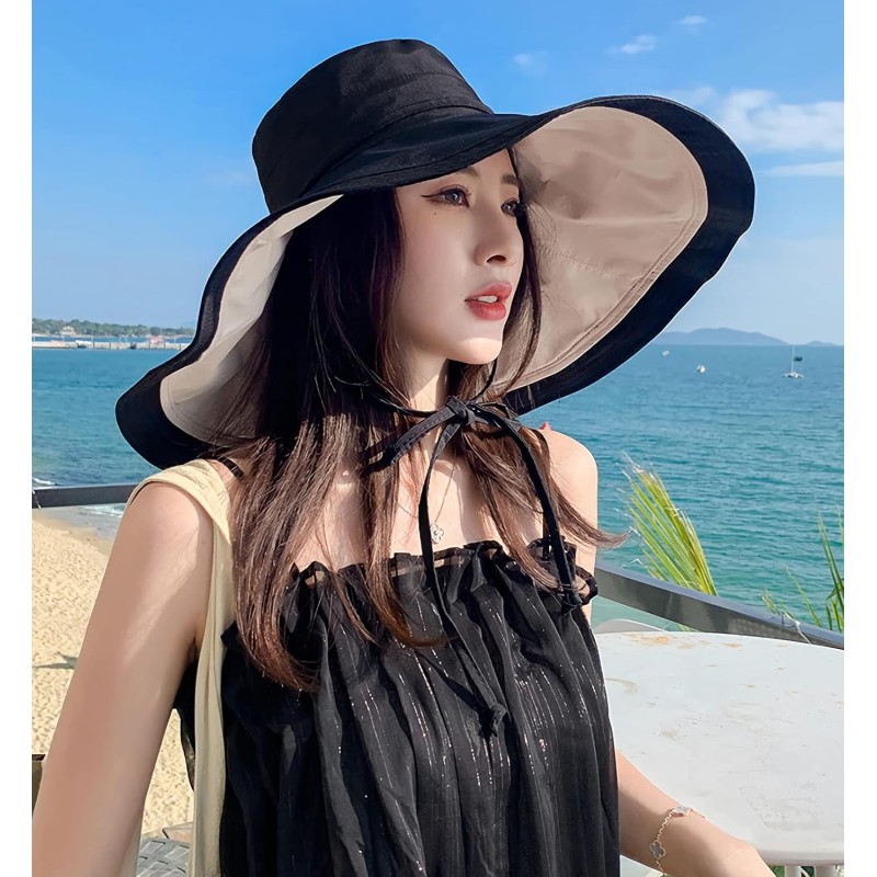 Woman wearing a reversible wide brim sun hat with UV protection at the beach