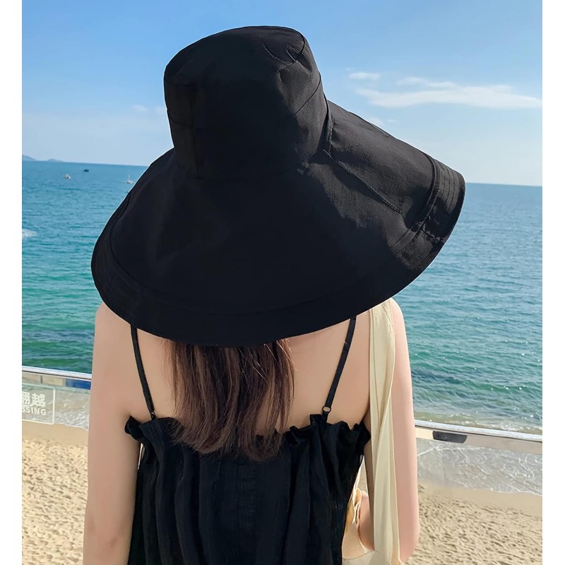 Woman wearing a reversible wide brim sun hat with UV protection at the beach