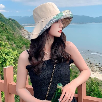 Woman wearing HUAMULAN reversible wide brim sun hat with UV protection