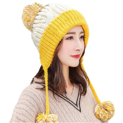 Women's beige yellow Peruvian ski beanie with 3 pom poms and ear flaps