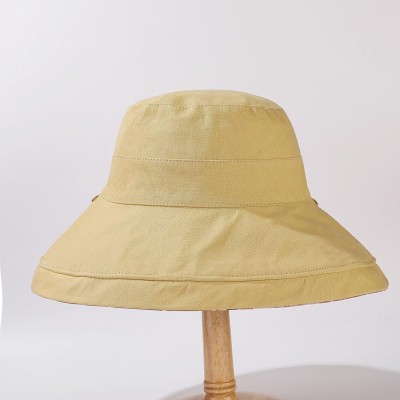 Women's wide brim sun hat with UV protection, reversible and packable for beach, fishing, hiking