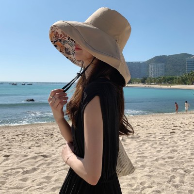Women's reversible wide brim sun hat with UV protection, packable for travel and beach