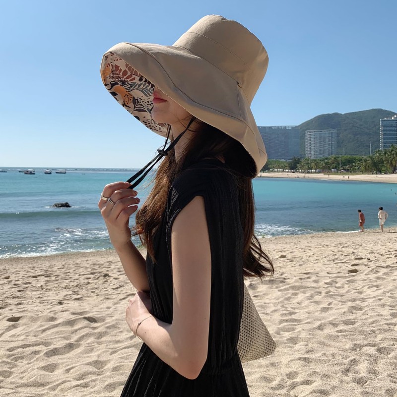 Women's reversible wide brim sun hat with UV protection, packable for travel and beach