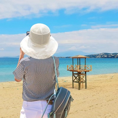 Women's Wide Brim Sun Hat – UPF 50+ Mesh Crown and Adjustable Chin Strap Women wearing wide brim sun hat with mesh crown and chin strap outdoors