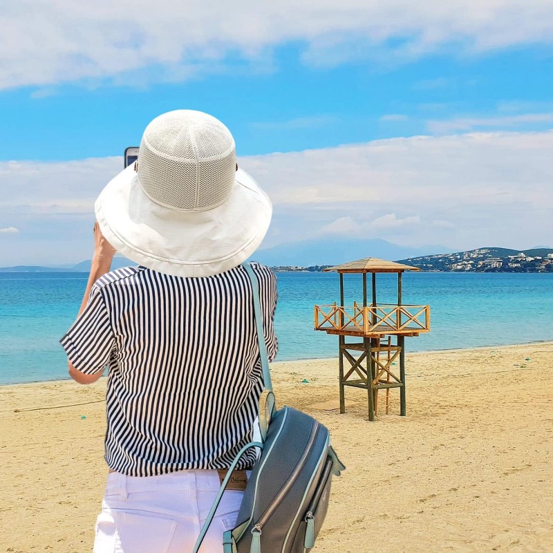 Women's Wide Brim Sun Hat – UPF 50+ Mesh Crown and Adjustable Chin Strap Women wearing wide brim sun hat with mesh crown and chin strap outdoors
