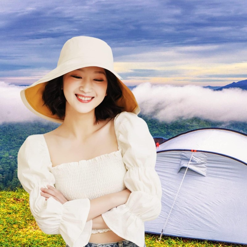 Women's Foldable Reversible Sun Hat Woman wearing a wide brim sun hat with UV protection