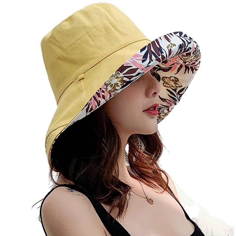 Woman wearing reversible wide brim sun hat with UPF 50+ at the beach