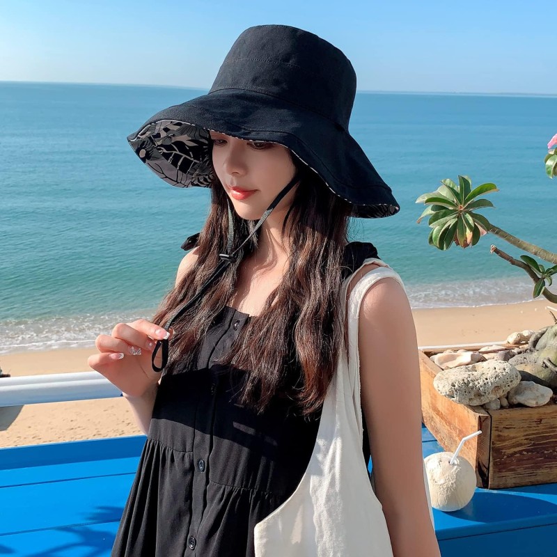Women's Reversible Wide Brim Sun Hat – UV Protection & Foldable Beach Hat Women wearing a reversible wide brim sun hat with UV protection at the beach